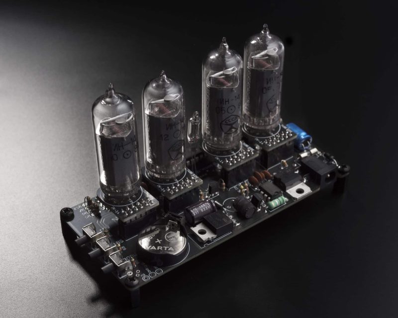 Rear view of the modular four-tube Nixie clock showing removable tube boards, battery and electronic components.