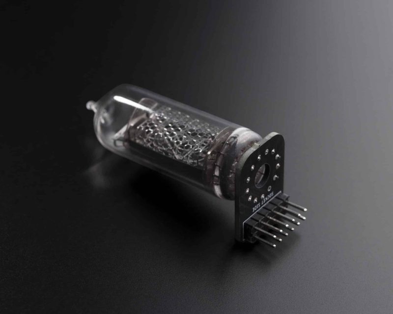 Nixie tube mounted on a removable adapter board with connector pins for the modular clock.