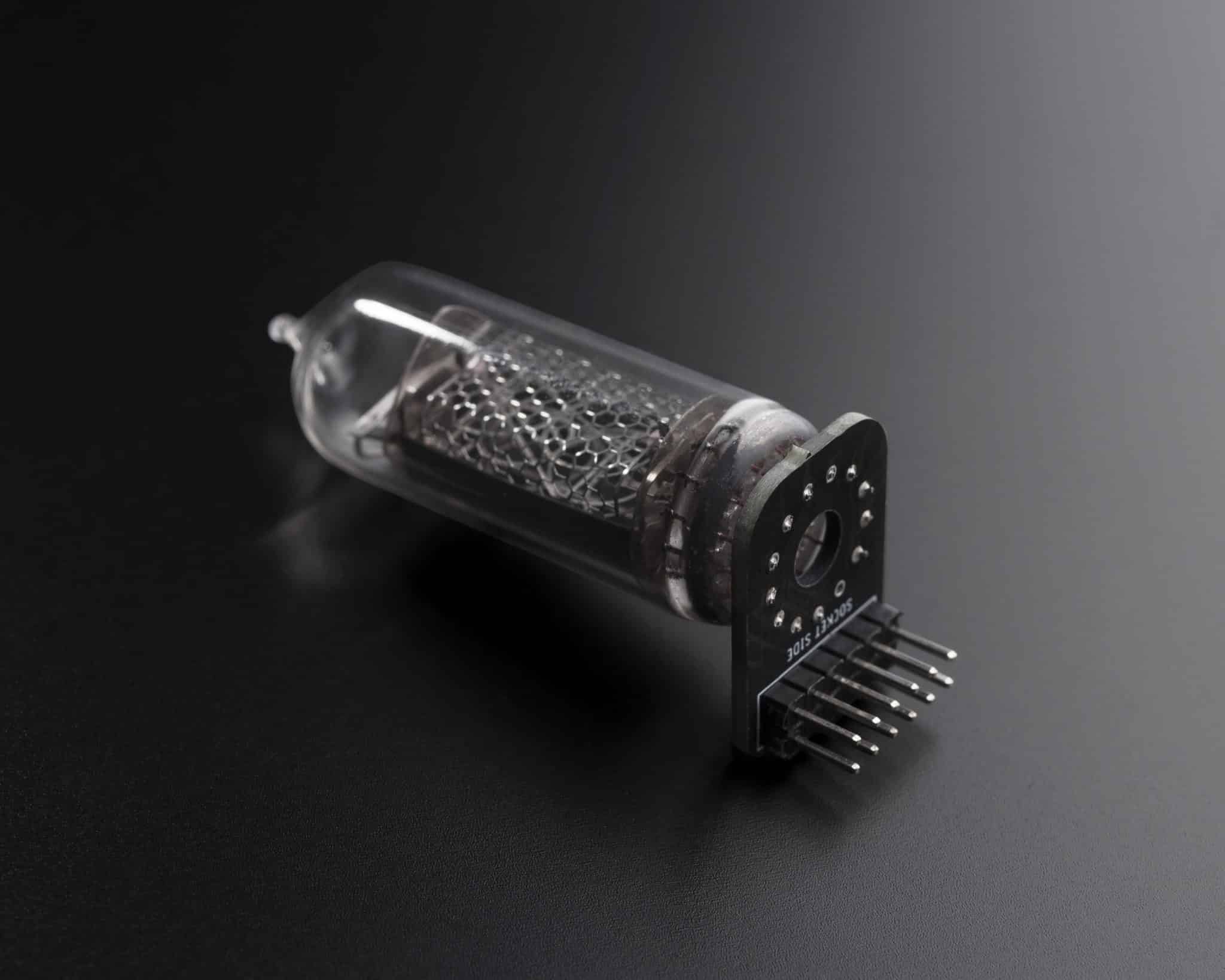 Nixie tube mounted on a removable adapter board with connector pins for the modular clock.